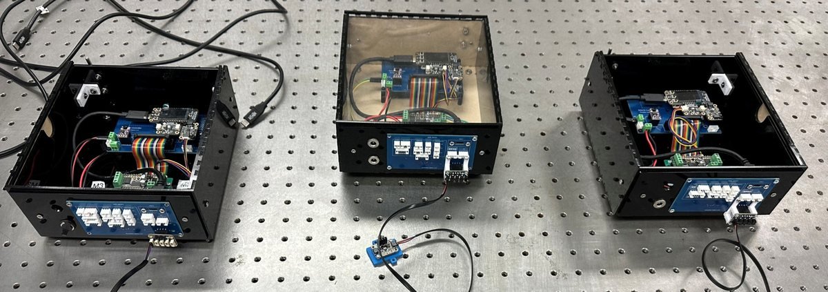 Three custom laser-cut measurement and control boxes with microprocessor electronics on optical bench